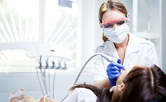 Student practices dental assisting skills. 
