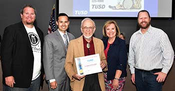 Then-TUSD Superintendent H.T. Sanchez recognizes longtime arts volunteer Dr. Ned Bloomfield at the December 2015 Board meeting.