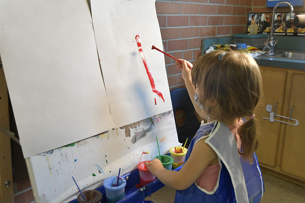 Young girl Painting on an Easel